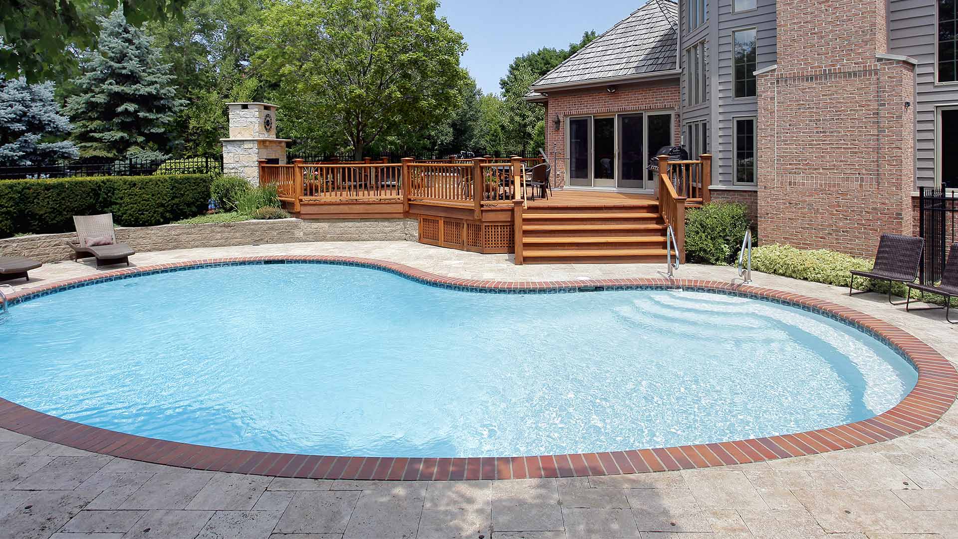 residential property backpatio with swimming curved swimming pool cedar park tx