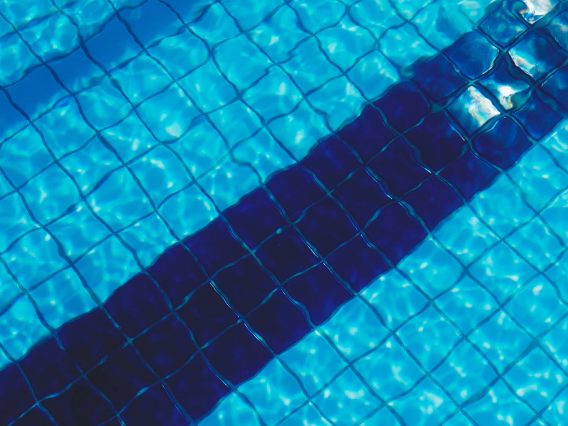 pool with a dark blue line of tiles at the bottom